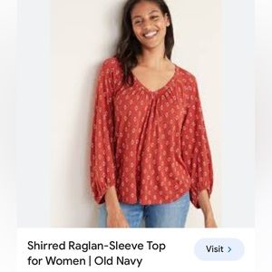 Rust orange with geometric pattern shirred raglan sleeve top